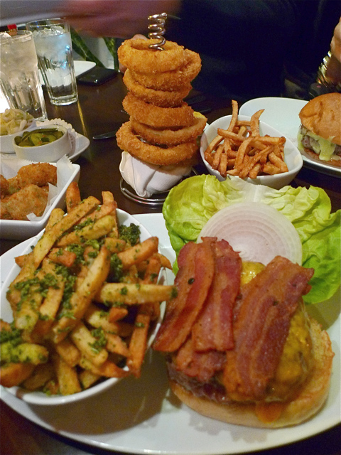 Rhapsody of denial: Giant burgers oozing fat, frites and onion rings. Photo: Steven Richter 