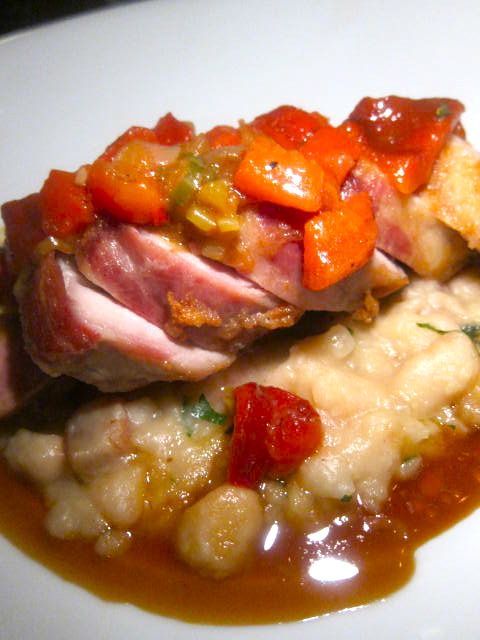 A pork cut from the shoulder is tender and rich on cannellini beans in bacon-cider jus.