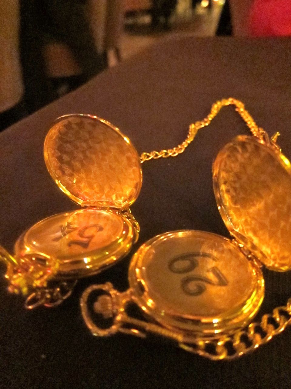 A golden locket on a chain holds your coat check number at Brasserie Pushkin. Photo: Gael Greene